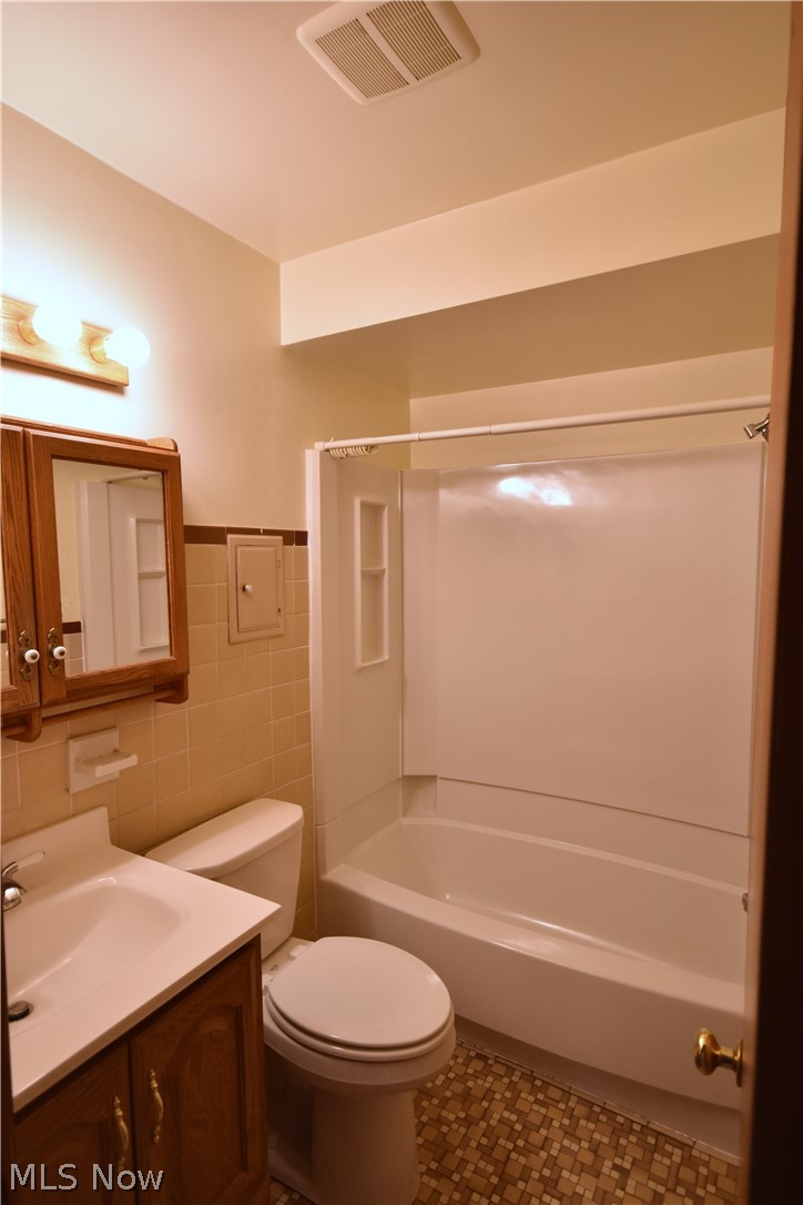 31921 Pendley Road Willowick, OH 44095 - Photo 14 of 22 Full bathroom with shower / washtub combination, tile walls, tile floors, toilet, and vanity