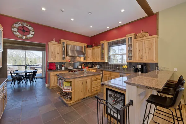 a kitchen with a stove a refrigerator and a dining table