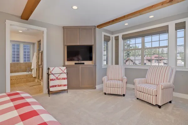 a bedroom with a bed and glass wall