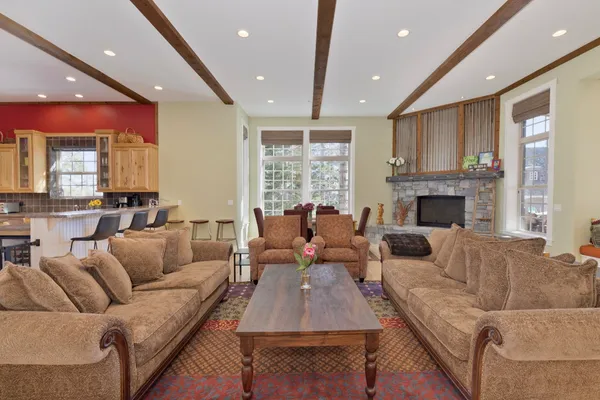 a living room with furniture fireplace and a large window