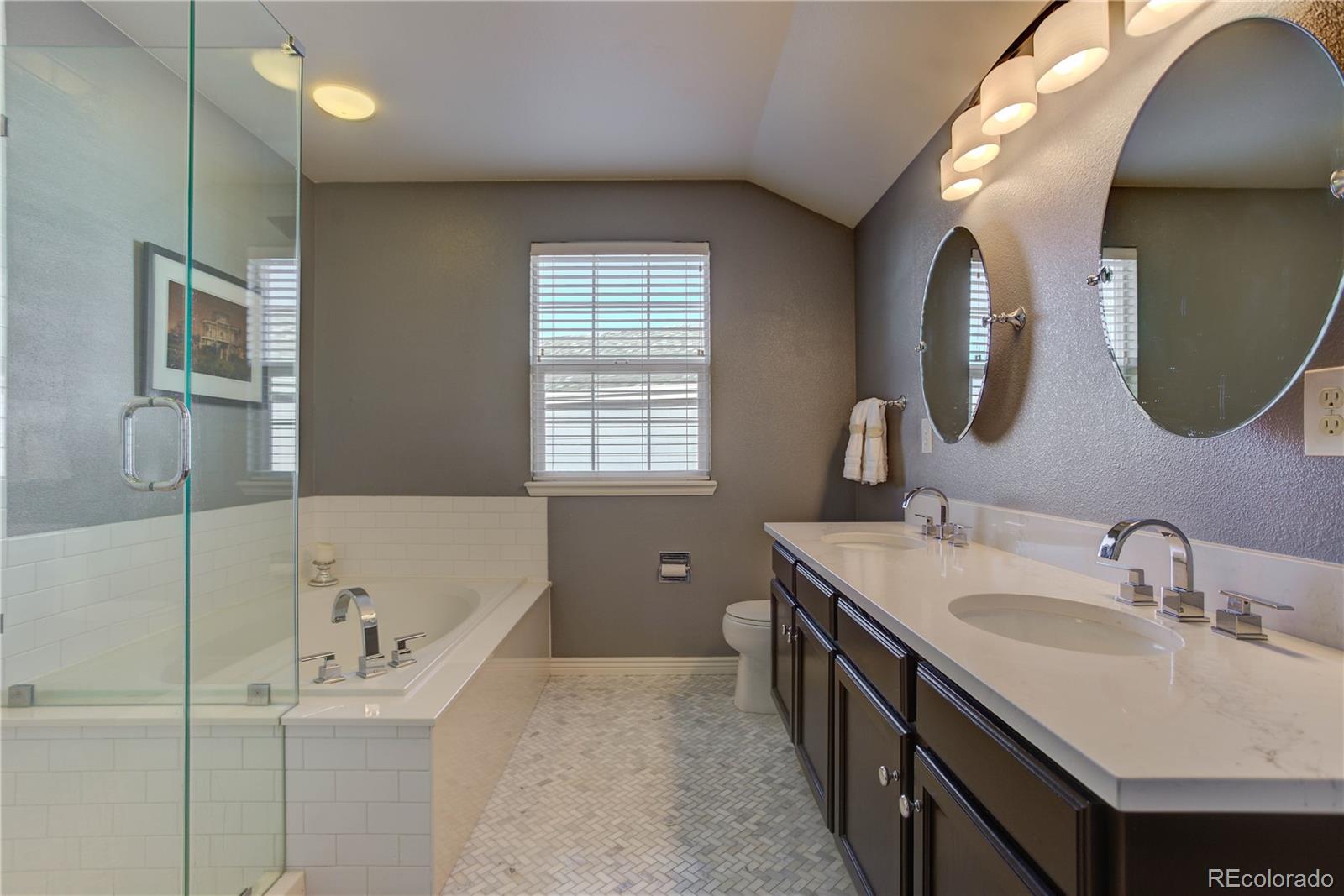 873 Riddlewood Lane Highlands Ranch, CO 80129 - Photo 25 of 35 a spacious bathroom with a double vanity sink mirror and bathtub