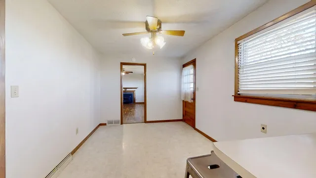 a view of a livingroom with a ceiling fan and window