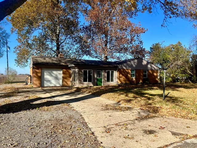 a view of a house with snow on the road