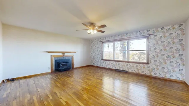 wooden floor in an empty room with a window