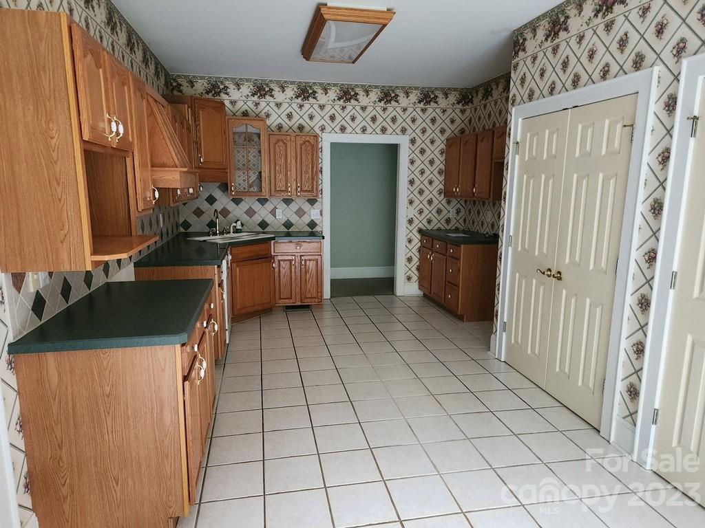 360 Hooper Creek Road Tryon, NC 28782 - Photo 20 of 38 a room with a washing machine and a stove top oven
