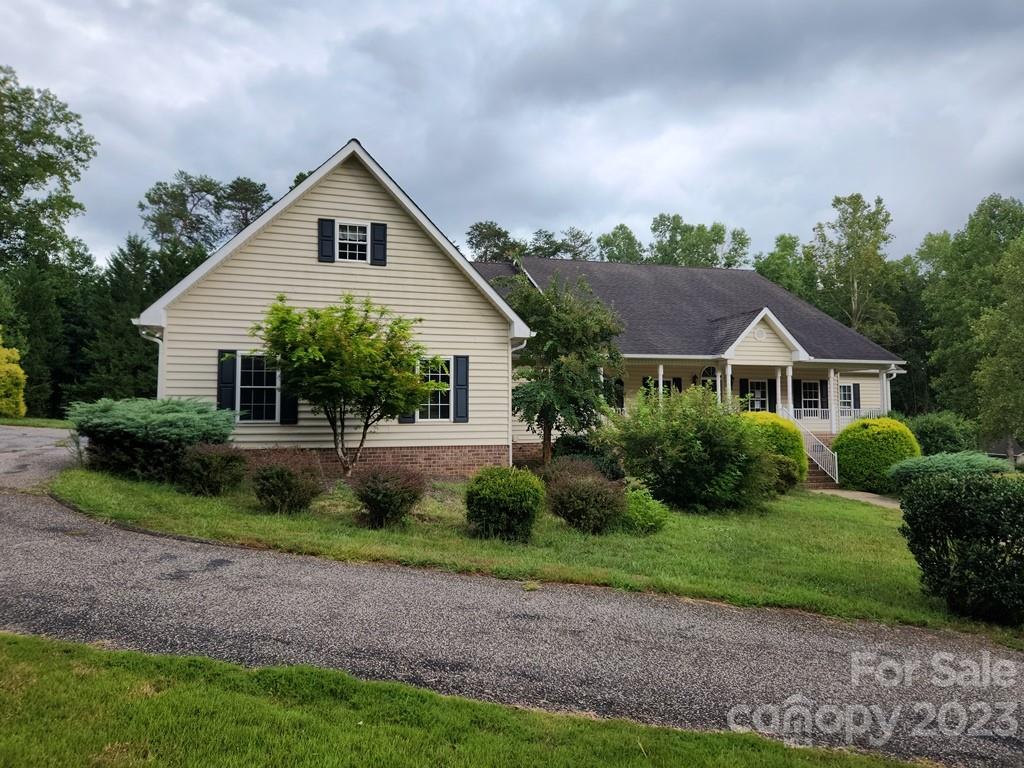 360 Hooper Creek Road Tryon, NC 28782 - Photo 2 of 38 a front view of a house with garden