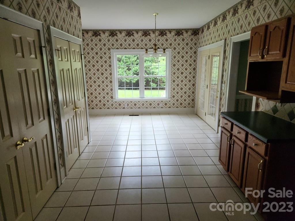 360 Hooper Creek Road Tryon, NC 28782 - Photo 21 of 38 a bathroom with a sink a mirror and a shower