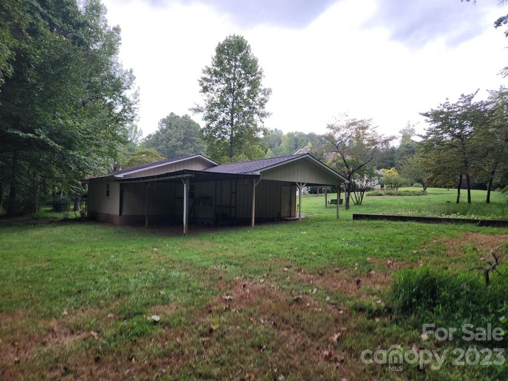 360 Hooper Creek Road Tryon, NC 28782 - Photo 10 of 38 a view of a house with backyard and trees