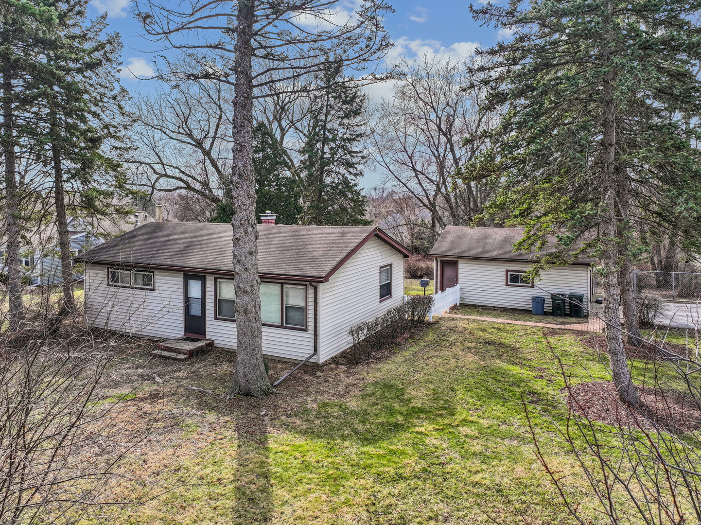a house that has a tree in front of it