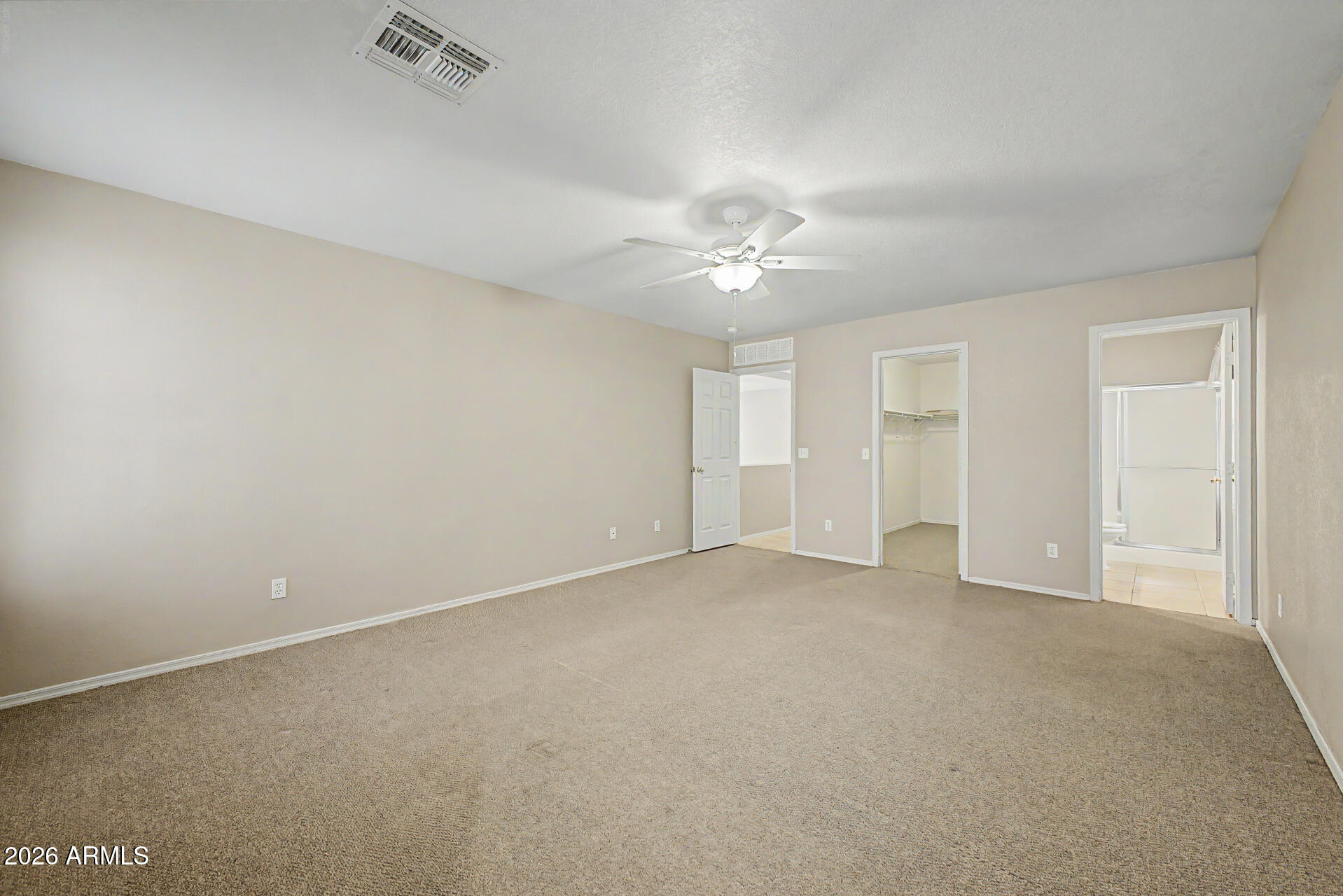 3489 South Bowman Road Apache Junction, AZ 85119 - Photo 4 of 24 an empty room with chandelier fan and windows