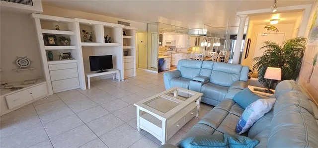 a living room with furniture and a floor to ceiling window