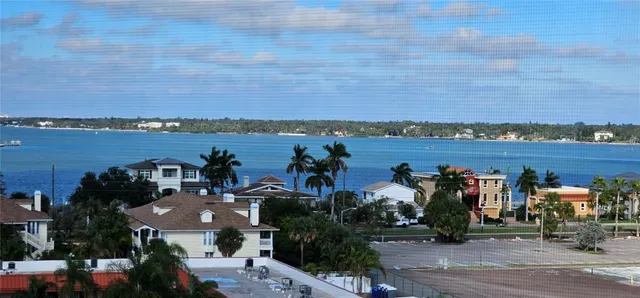a view of a balcony with wooden floor and fence