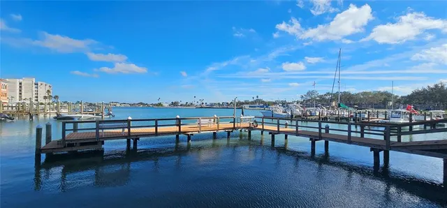 a view of a chairs and table in patio with a barbeque