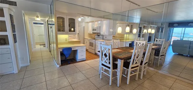 a kitchen with granite countertop a sink stove and refrigerator