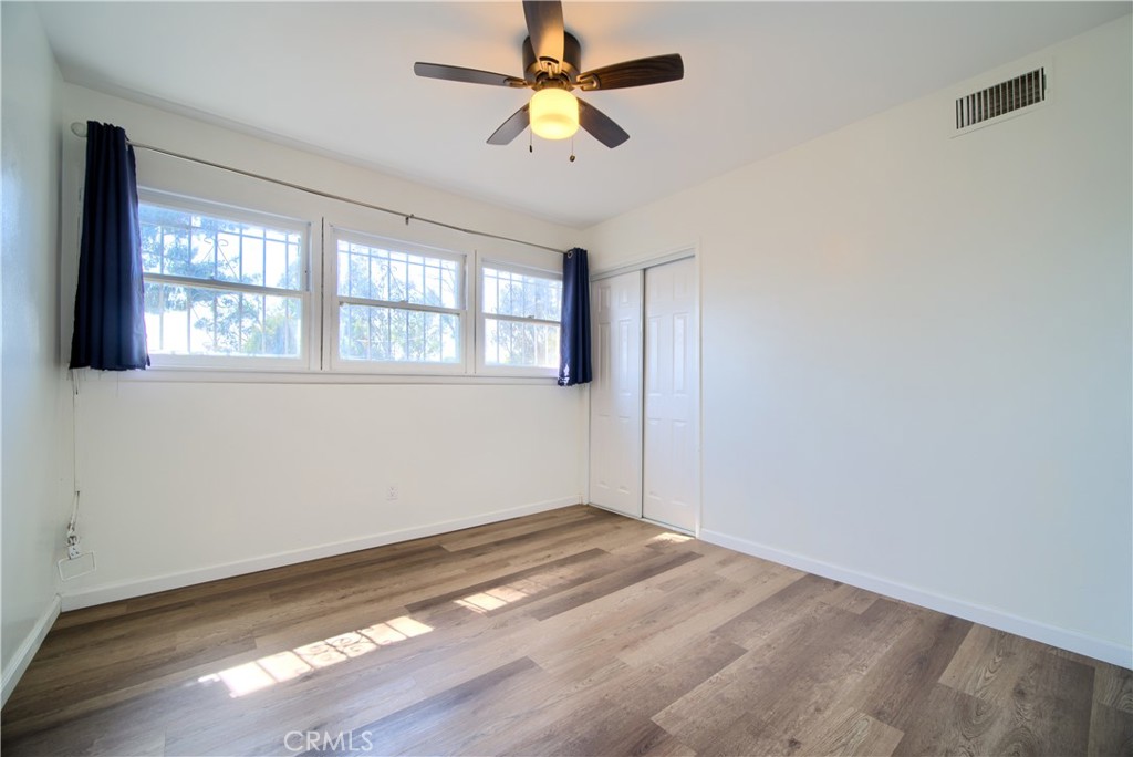 6083 Merito Avenue San Bernardino, CA 92404 - Photo 11 of 17 wooden floor in an empty room with a window