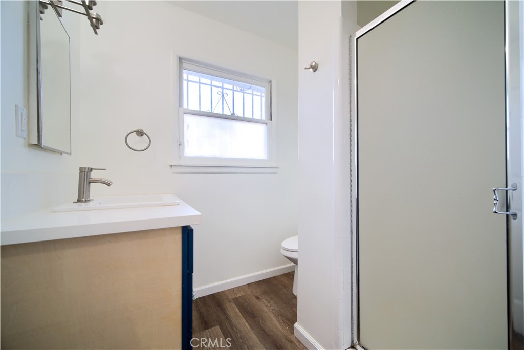 6083 Merito Avenue San Bernardino, CA 92404 - Photo 13 of 17 a bathroom with a sink a toilet and a window