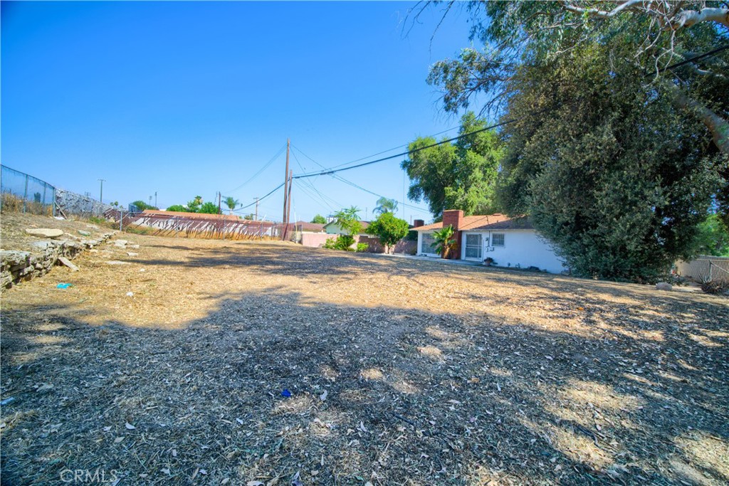 6083 Merito Avenue San Bernardino, CA 92404 - Photo 16 of 17 a view of a house with a yard and sitting area