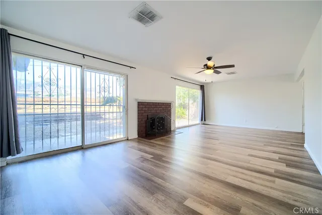 wooden floor in an empty room with a fireplace