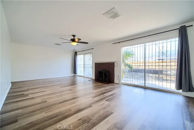 wooden floor in an empty room with a fireplace