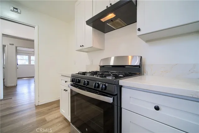 a kitchen with stainless steel appliances white cabinets and a stove