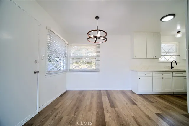 a kitchen with wooden floors and window