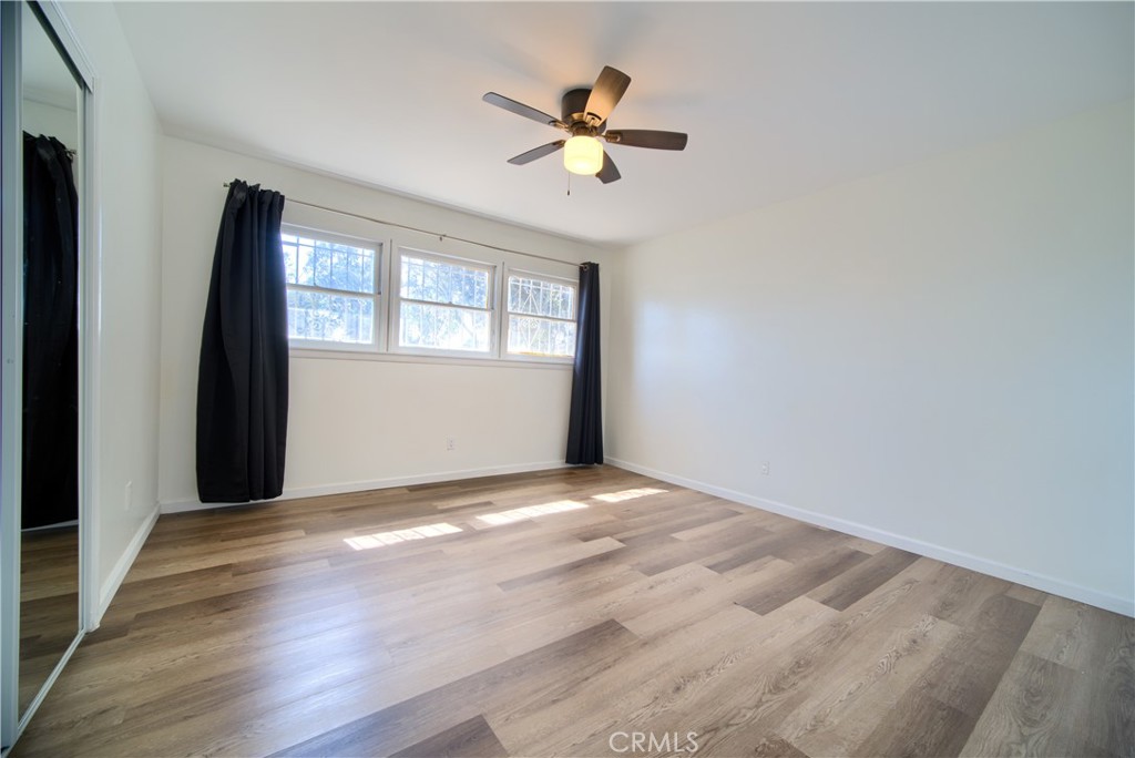 6083 Merito Avenue San Bernardino, CA 92404 - Photo 10 of 17 a view of empty room with wooden floor and fan