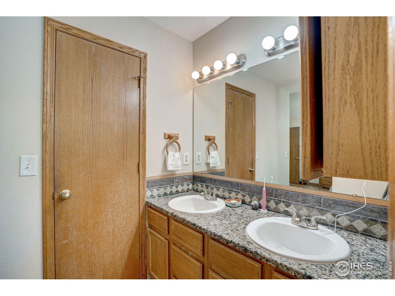 3317 Laredo Lane Fort Collins, CO 80526 - Photo 13 of 33 a bathroom with a double vanity sink and a mirror
