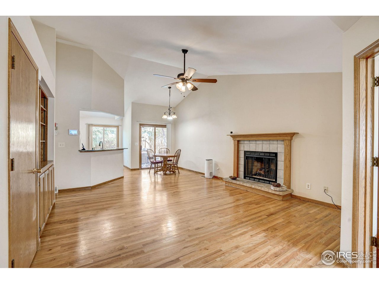 3317 Laredo Lane Fort Collins, CO 80526 - Photo 2 of 33 a view of empty room with fireplace and wooden floor
