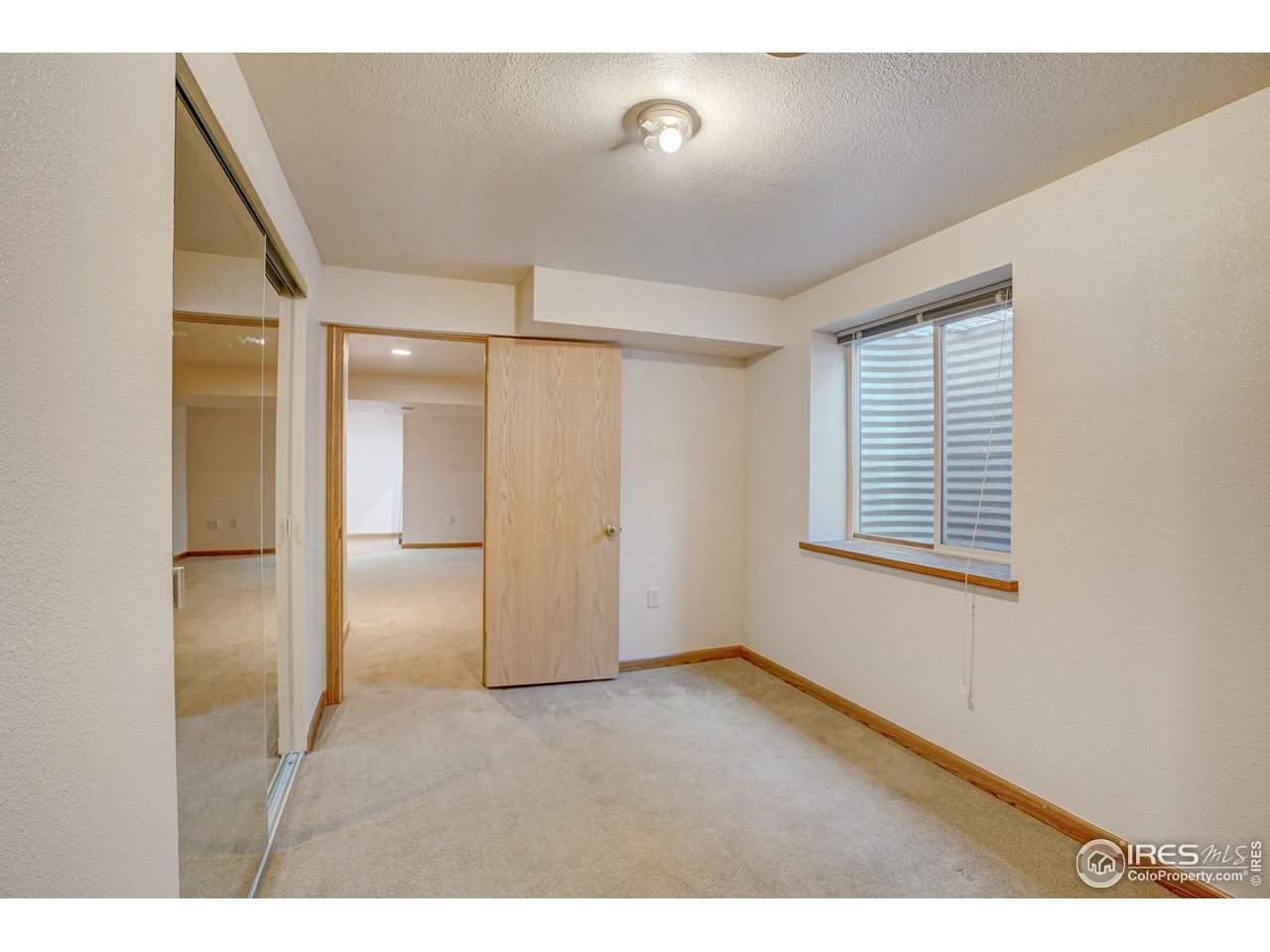 3317 Laredo Lane Fort Collins, CO 80526 - Photo 22 of 33 a view of an empty room with a window