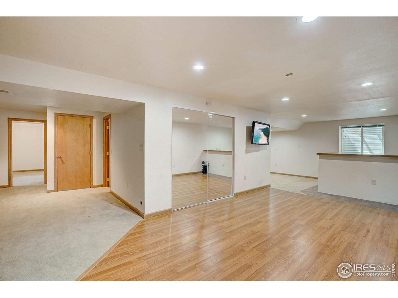 3317 Laredo Lane Fort Collins, CO 80526 - Photo 24 of 33 a view of an empty room with wooden floor