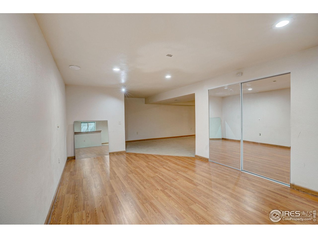 3317 Laredo Lane Fort Collins, CO 80526 - Photo 26 of 33 a view of an empty room with wooden floor