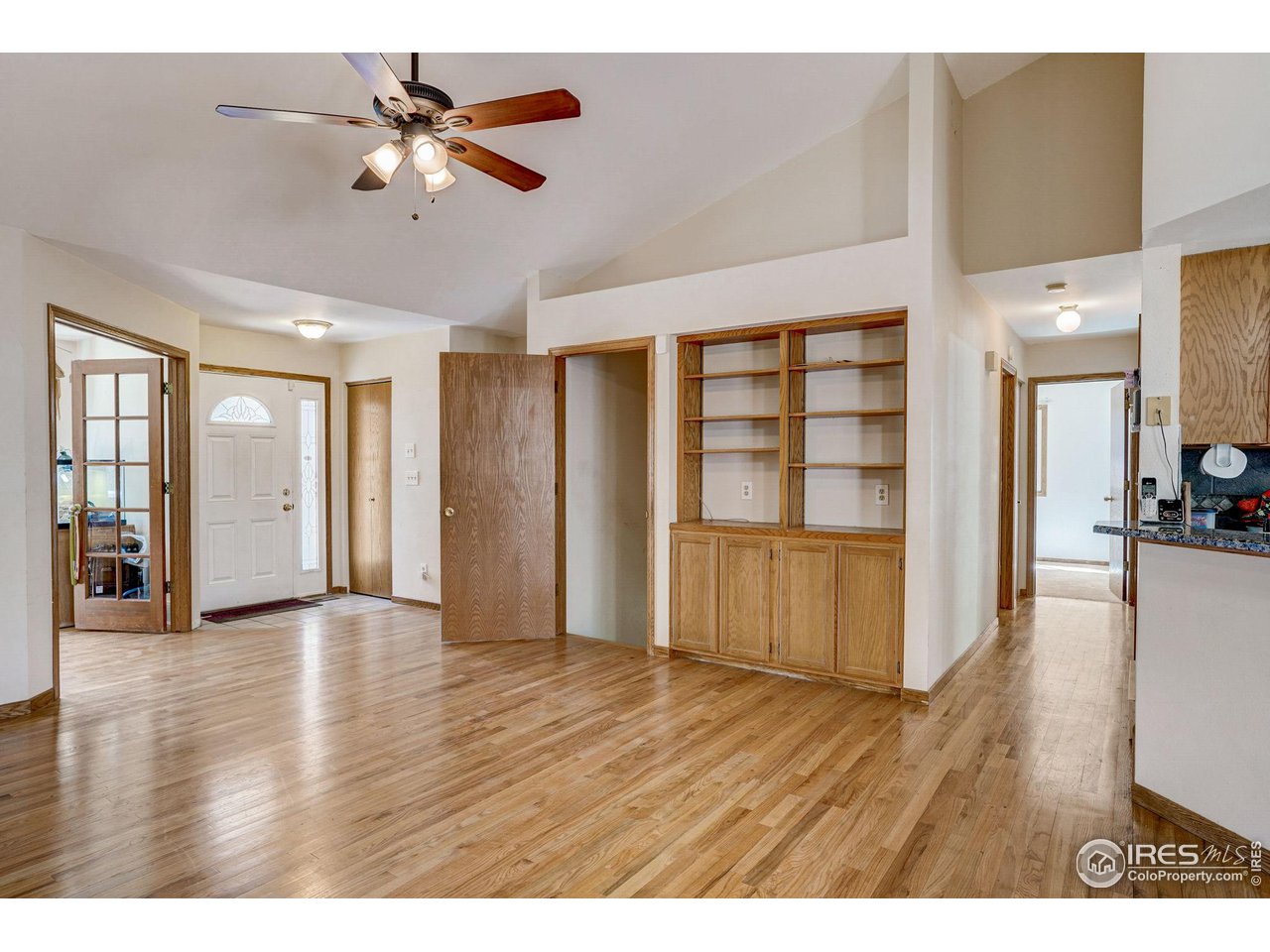 3317 Laredo Lane Fort Collins, CO 80526 - Photo 3 of 33 a view of an empty room with window and wooden floor