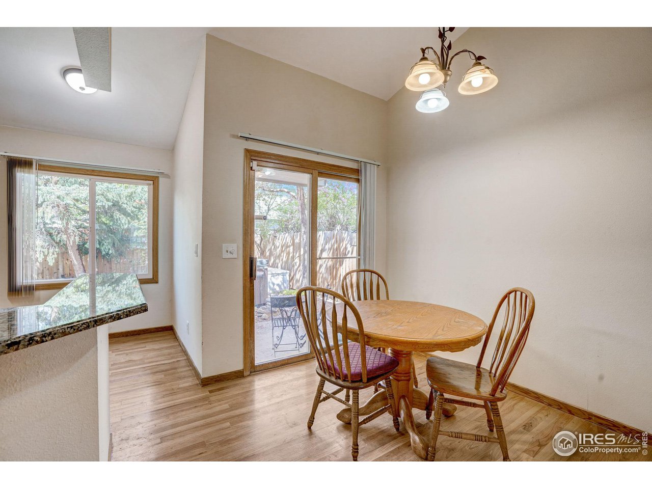 3317 Laredo Lane Fort Collins, CO 80526 - Photo 6 of 33 a view of a dining room with furniture wooden floor and a chandelier