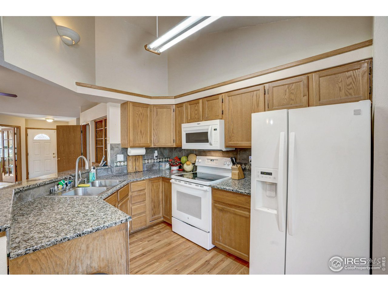 3317 Laredo Lane Fort Collins, CO 80526 - Photo 7 of 33 a kitchen with refrigerator and cabinets