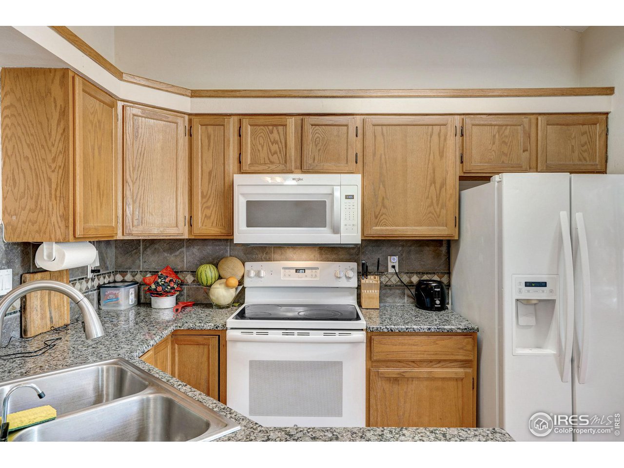 3317 Laredo Lane Fort Collins, CO 80526 - Photo 8 of 33 a kitchen with a refrigerator and a sink