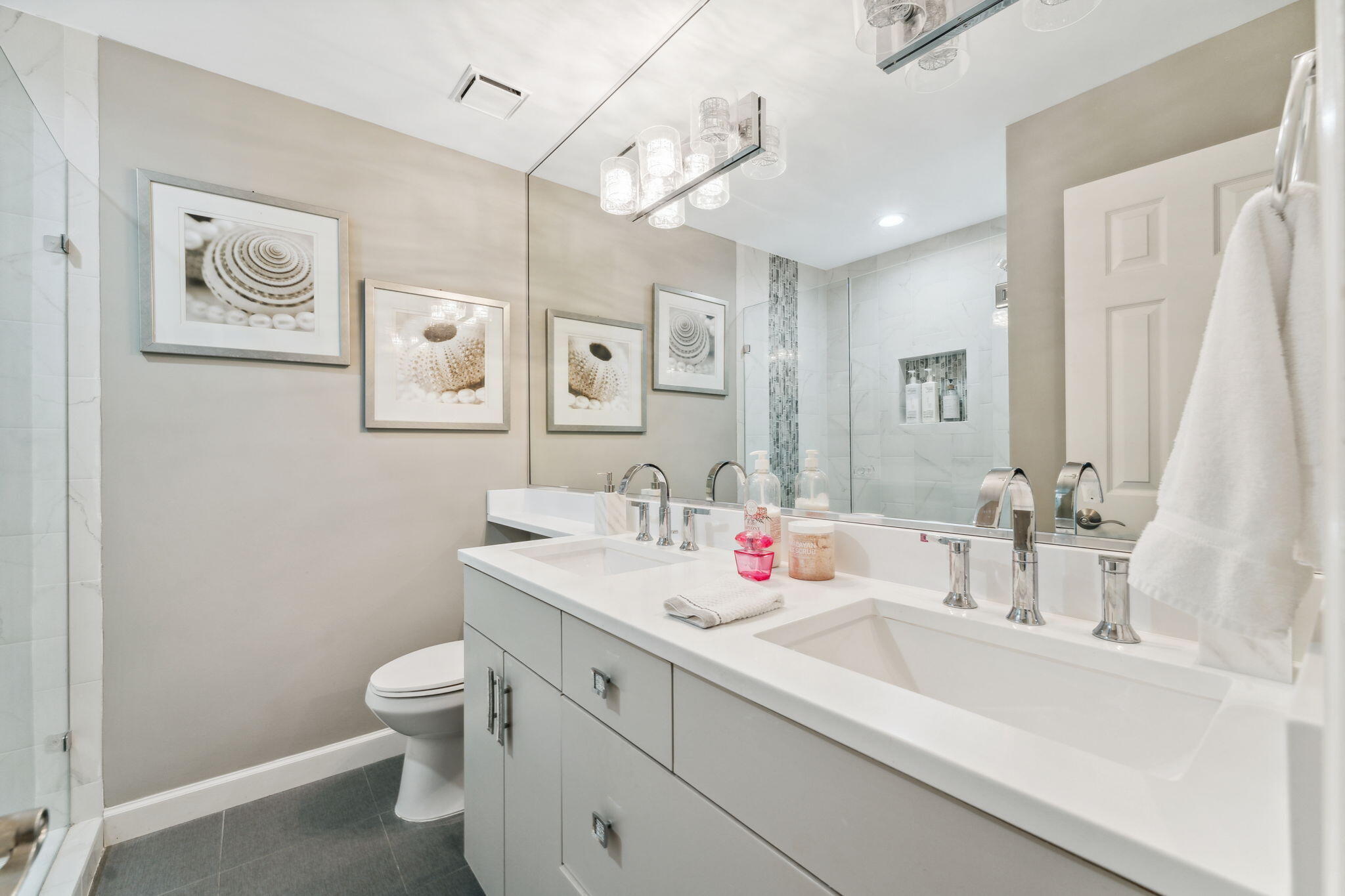 23011 Front Beach Road, Unit E47 Panama City Beach, FL 32413 - Photo 18 of 29 a bathroom with a toilet sink and mirror