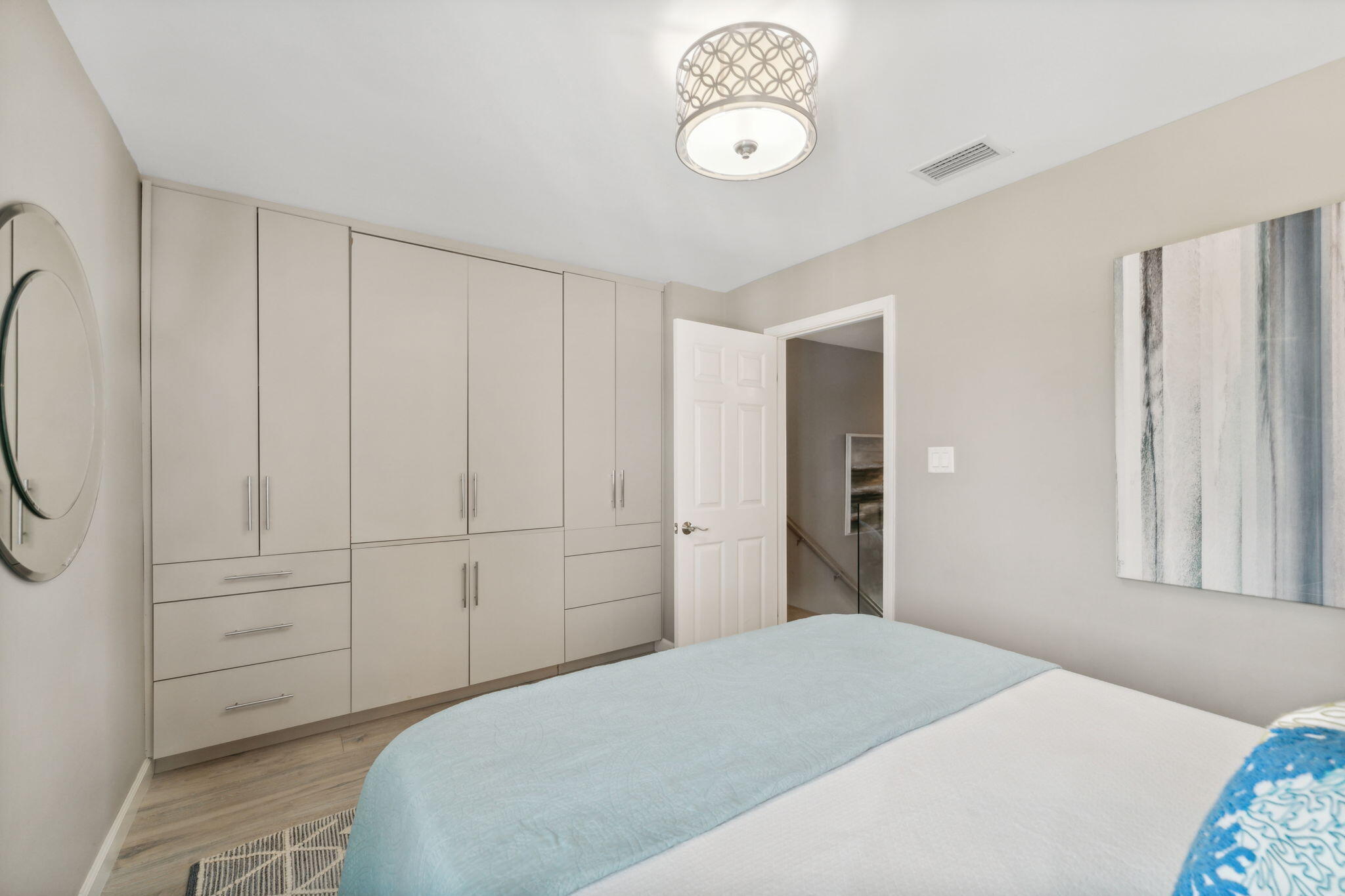 23011 Front Beach Road, Unit E47 Panama City Beach, FL 32413 - Photo 24 of 29 a bedroom with a bed and a chandelier