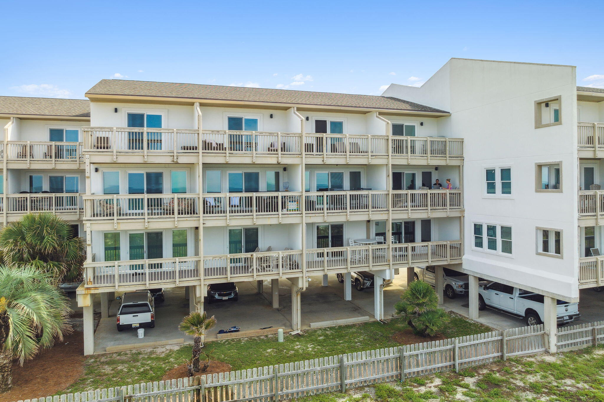23011 Front Beach Road, Unit E47 Panama City Beach, FL 32413 - Photo 28 of 29 a front view of a building with glass windows and a yard