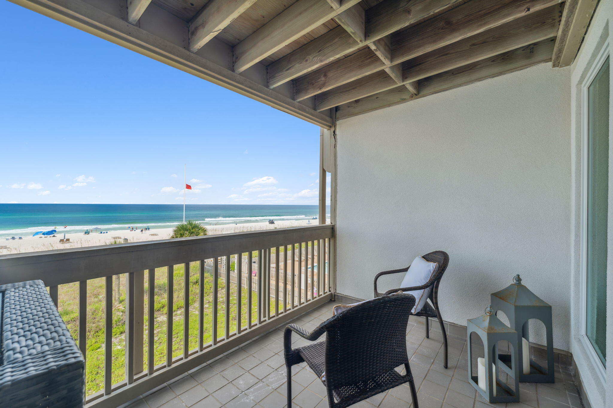 23011 Front Beach Road, Unit E47 Panama City Beach, FL 32413 - Photo 8 of 29 a view of a balcony with chair and wooden floor