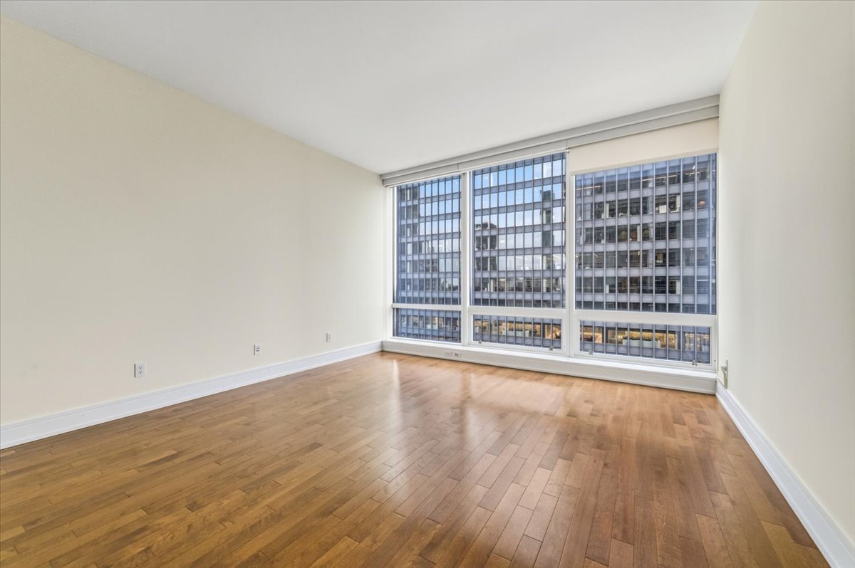 401 North Wabash Avenue, Unit 31G Chicago, IL 60611 - Photo 11 of 46 wooden floor in an empty room with a window