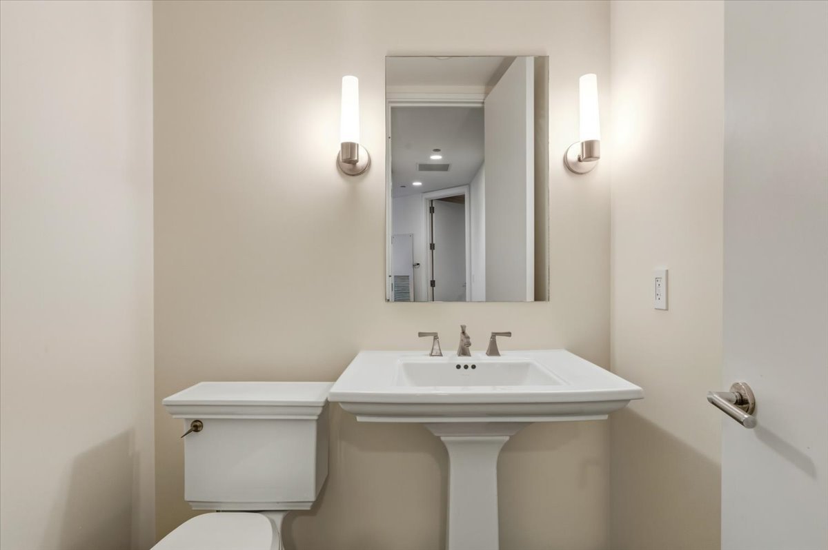 401 North Wabash Avenue, Unit 31G Chicago, IL 60611 - Photo 13 of 46 a bathroom with a sink toilet and a mirror