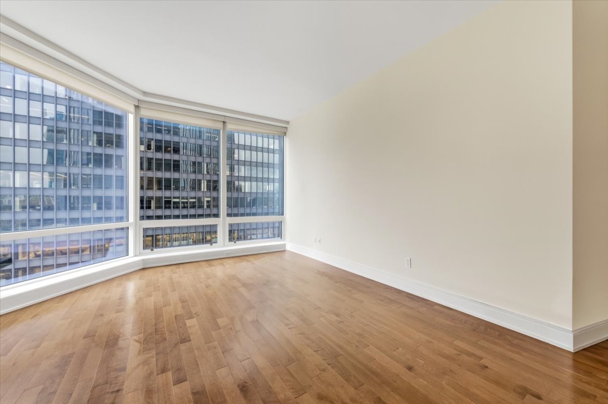 401 North Wabash Avenue, Unit 31G Chicago, IL 60611 - Photo 17 of 46 an empty room with wooden floor and windows