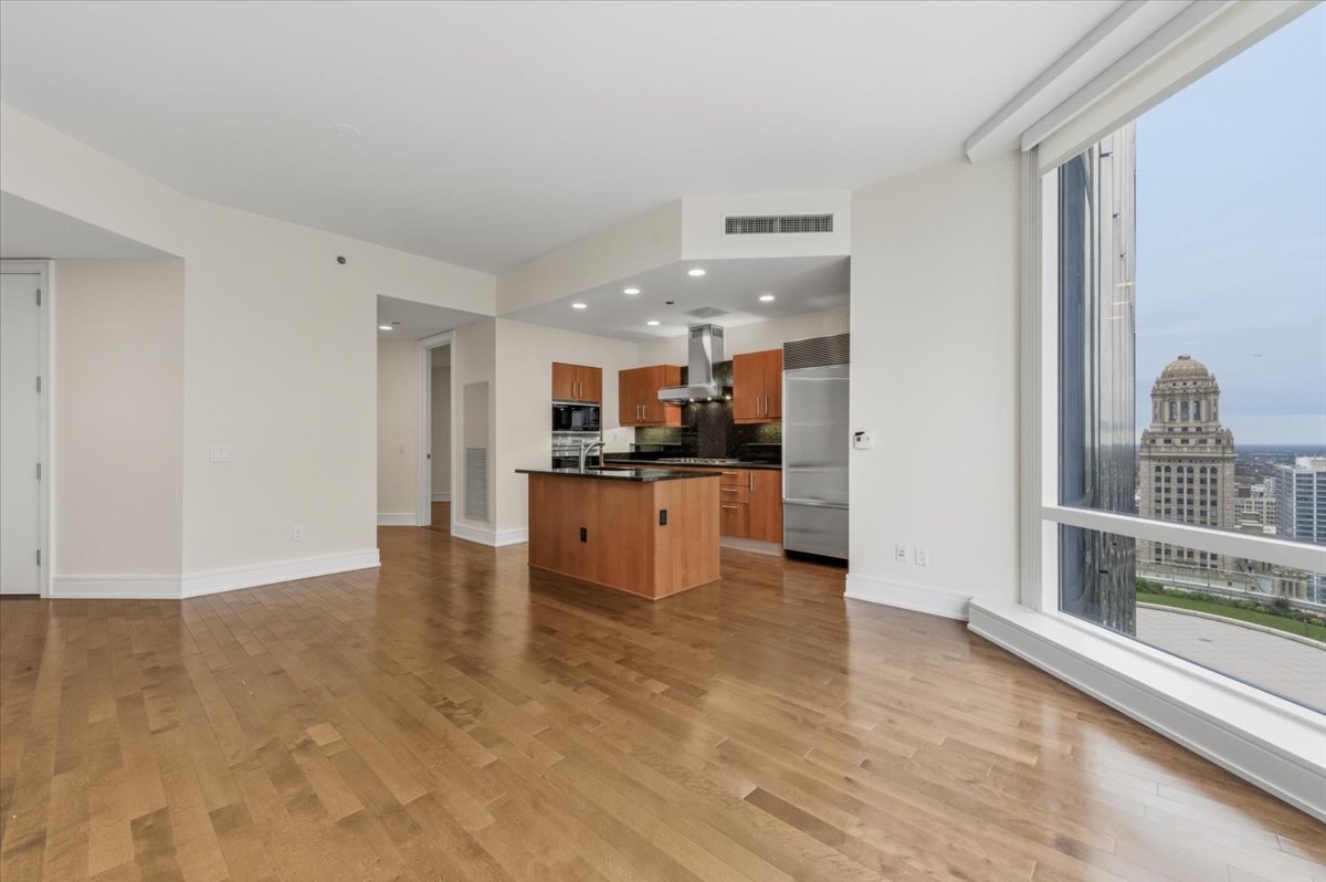401 North Wabash Avenue, Unit 31G Chicago, IL 60611 - Photo 18 of 46 a view of kitchen with kitchen island granite countertop a refrigerator and a sink