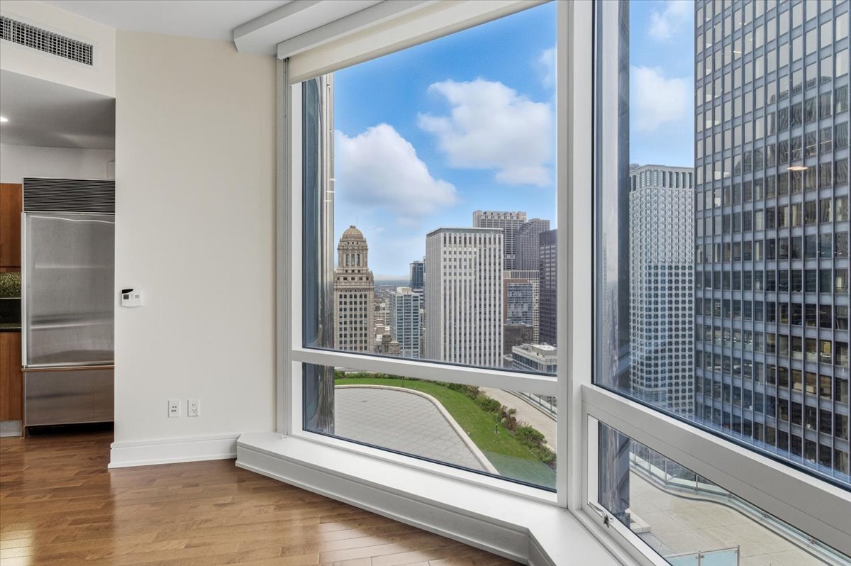 401 North Wabash Avenue, Unit 31G Chicago, IL 60611 - Photo 7 of 46 a view of a balcony with a floor to ceiling window and wooden floor
