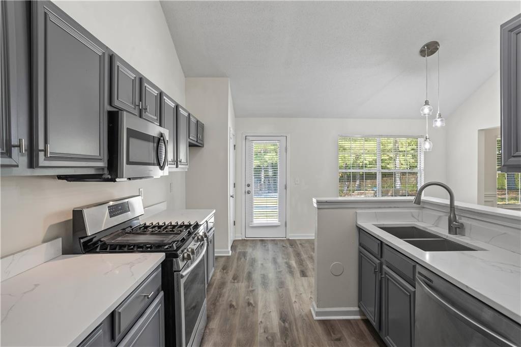 6639 Overlook Ridge Atlanta, GA 30349 - Photo 11 of 35 a kitchen that has a sink and a stove