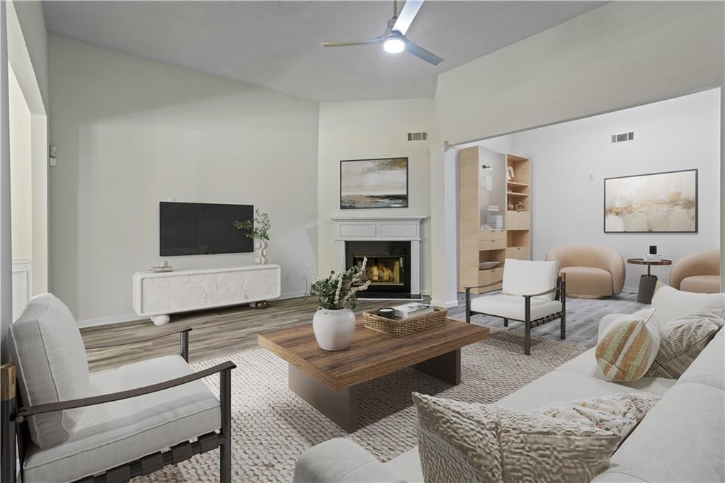 6639 Overlook Ridge Atlanta, GA 30349 - Photo 5 of 35 a living room with furniture a flat screen tv and a fireplace