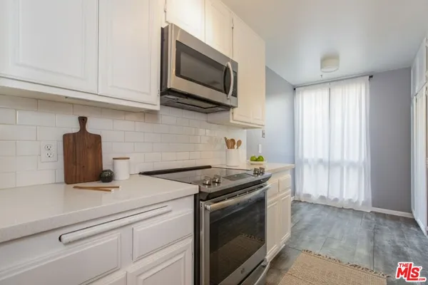 a kitchen with stainless steel appliances a stove a sink and a refrigerator