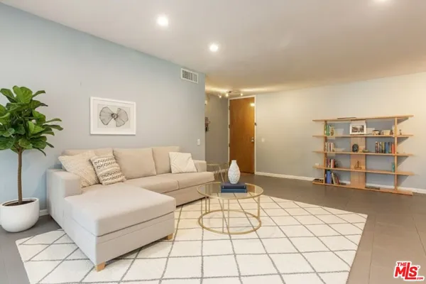 a living room with furniture and flowers