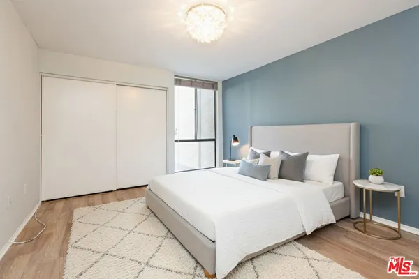 a bedroom with a bed and a chandelier
