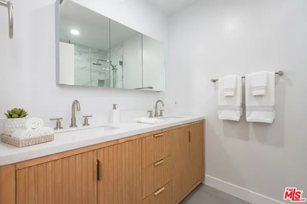 a kitchen with stainless steel appliances granite countertop a sink a stove and cabinets